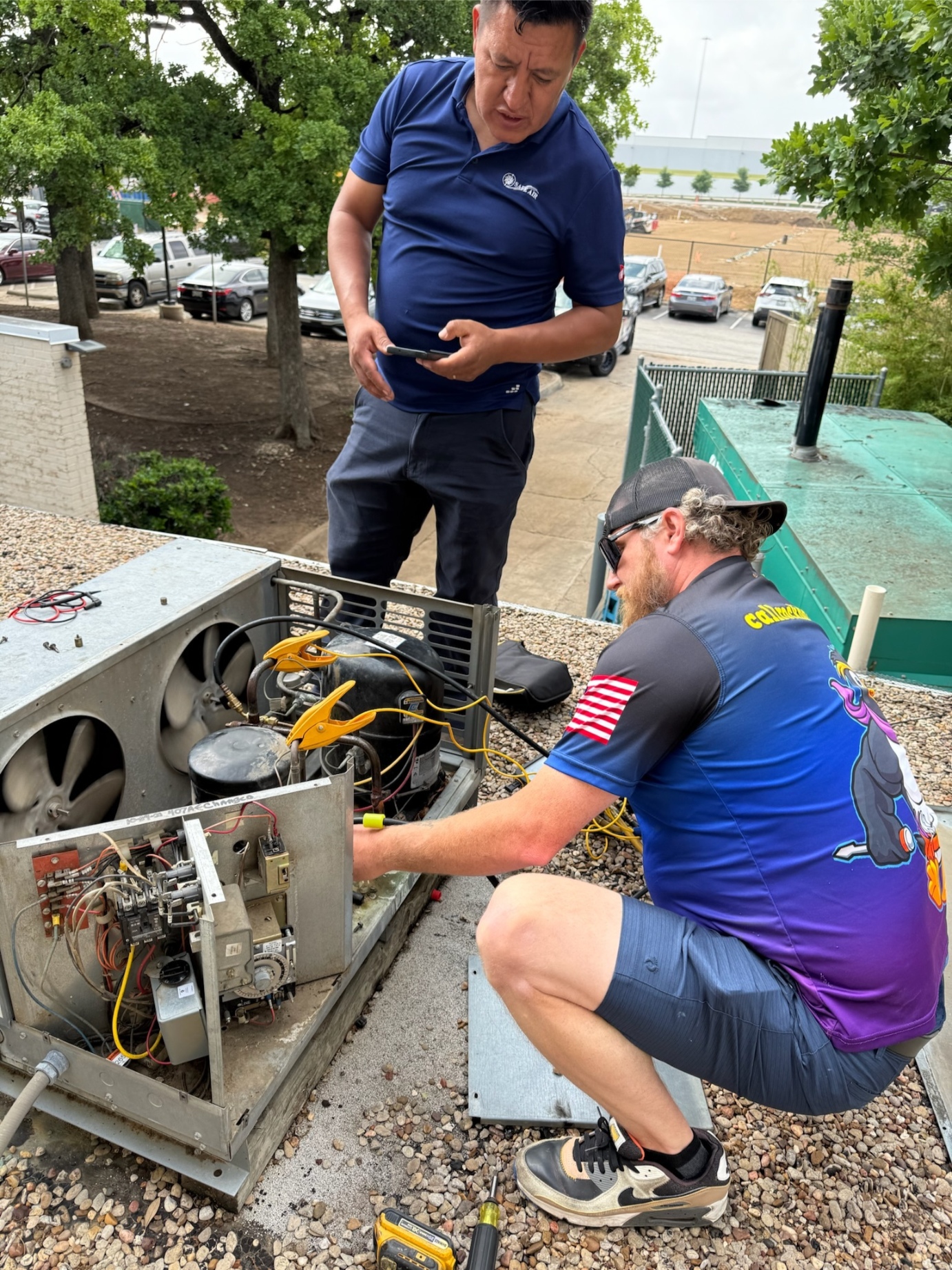 Rock Hard technicians diagnosing rooftop mini-split condenser