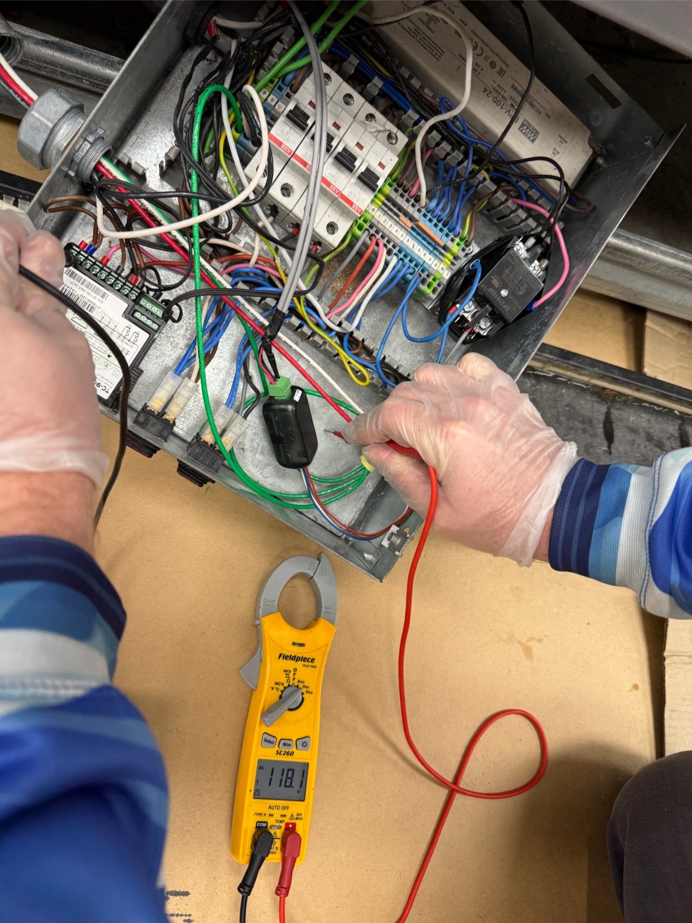 Rock Hard technician running control board diagnostics with Fieldpiece clamp meter