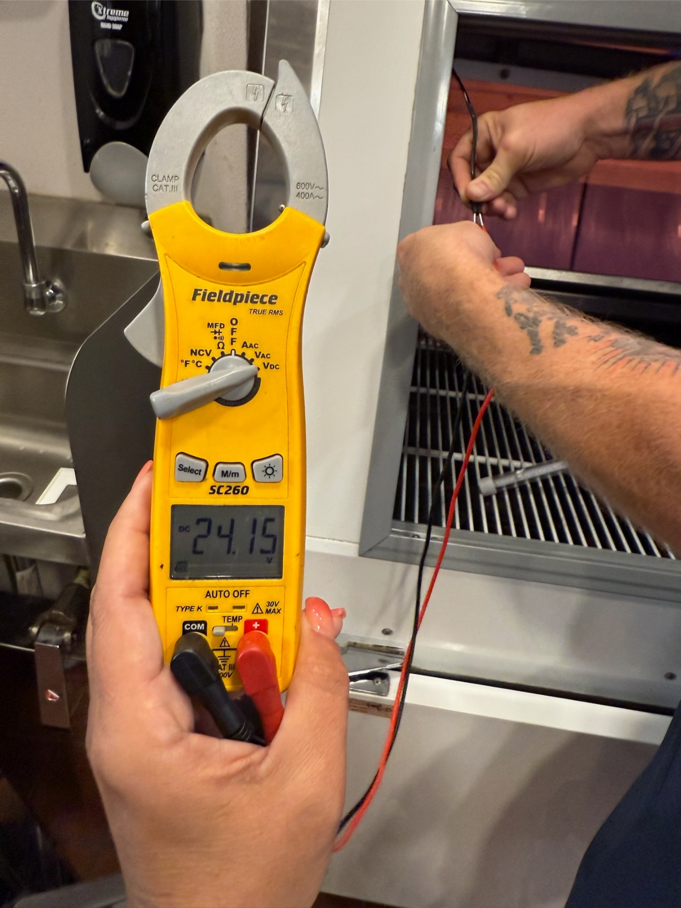 Rock Hard technician running commercial refrigeration diagnostics with Fieldpiece meter — Plano TX service call