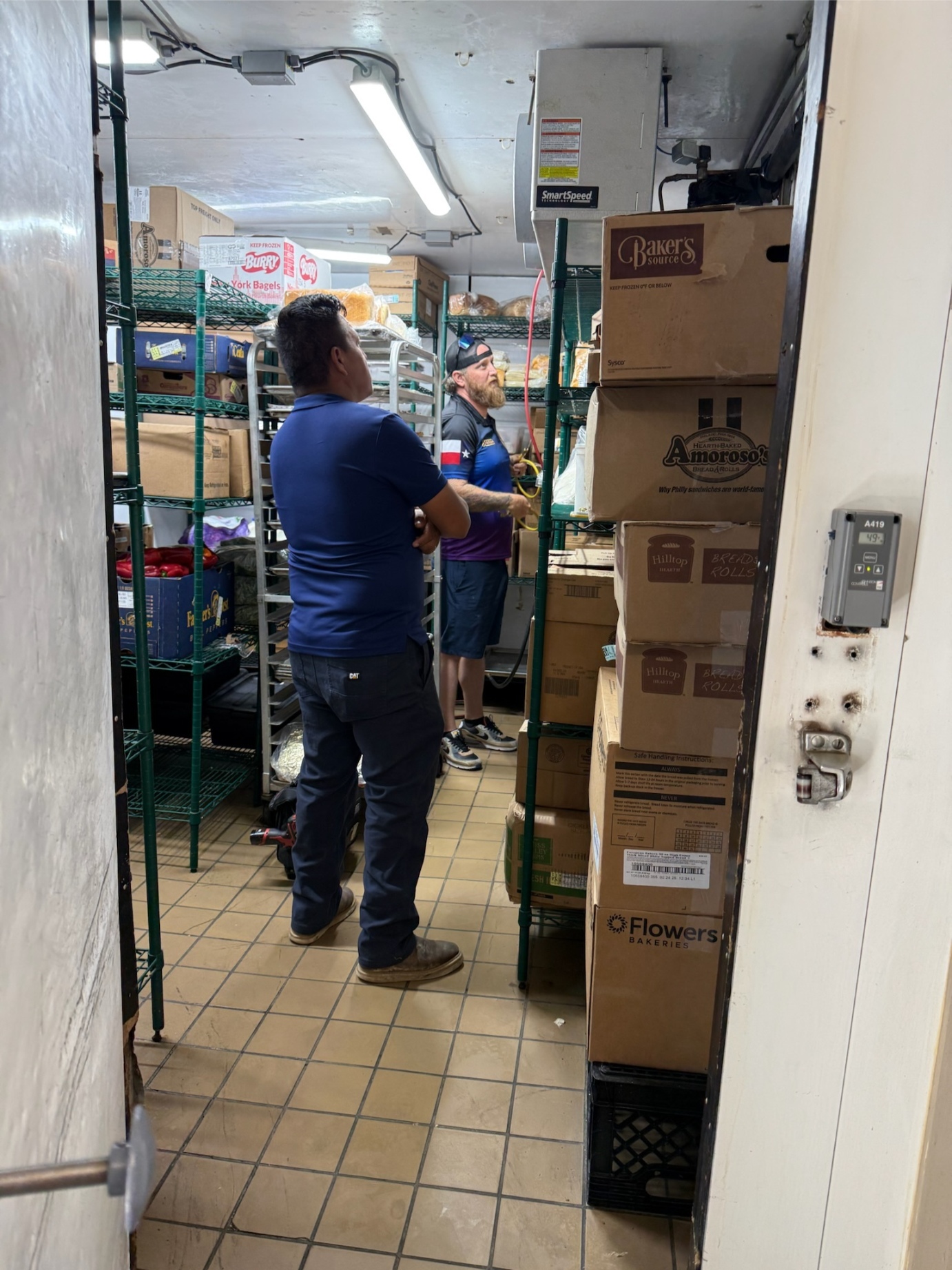 Rock Hard technicians servicing walk-in cooler evaporator unit